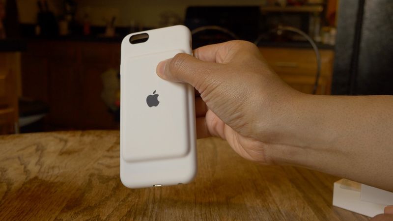 A photo showing a hand holding Apple