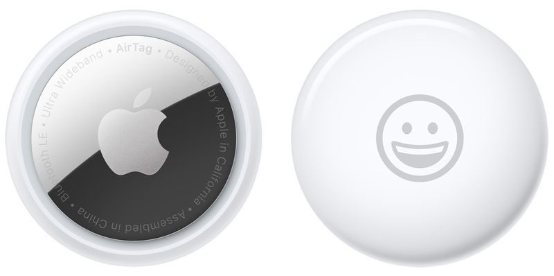 A promotional image from Apple showing the back and front of the AirTag personal item tracker with a smiley emoji engraved