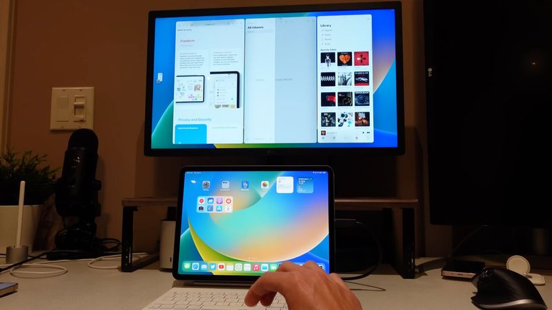 An iPad connected to an external monitor running three apps at once using Apple