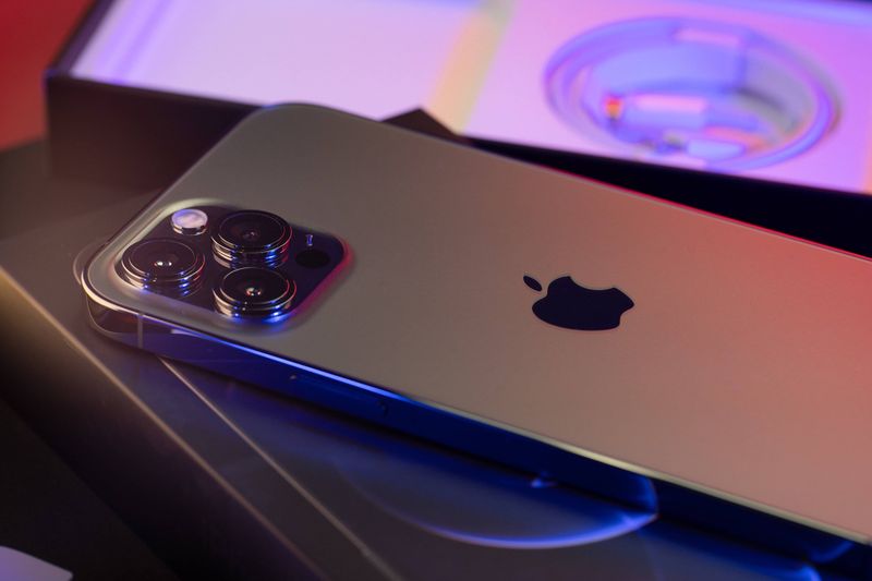 A photograph showing Apple iPhone 13 Pro Max laid facedown on its packaging, showing exposing the rear cameras