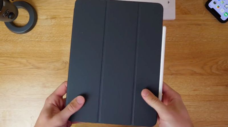 A photo showing an iPad Pro in a Smart Folio case, held in hand