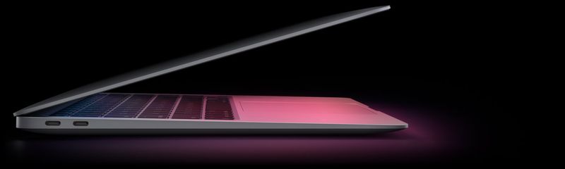 An image showing the M1 MacBook Air set against a dark background, with the lid half open