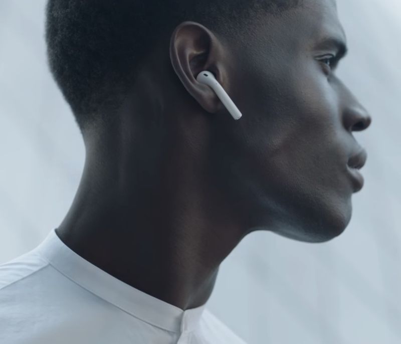 Male headshot showing a profile of a young person wearing an AirPod in their left ear