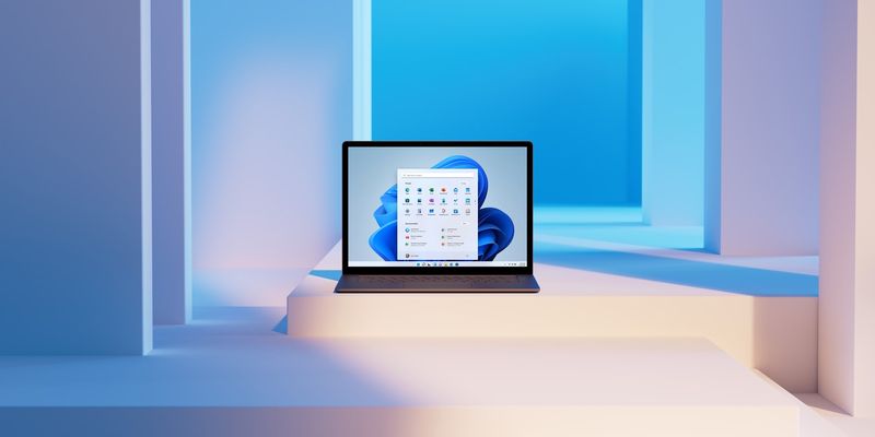 A Microsoft promotional image showing a Windows 11 PC with the centered Start menu