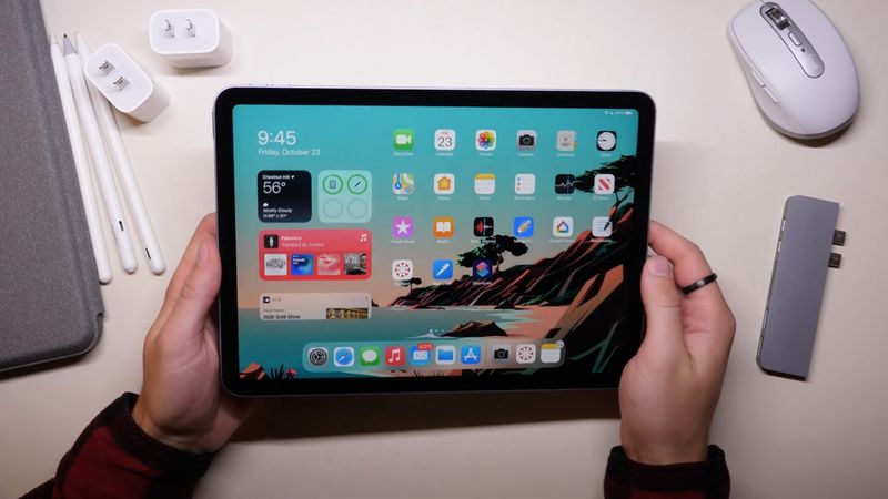 A photo showing a person holding a 12.9-inch iPad Pro in their hands